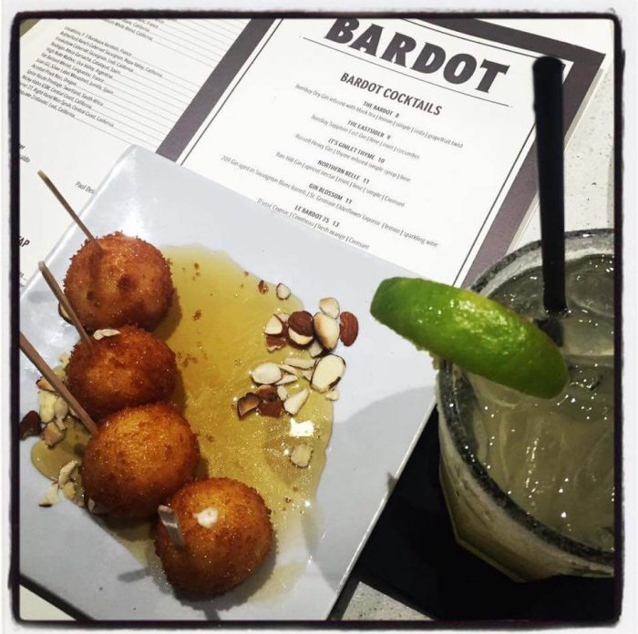 The Bardot menu with an appetizer and a drink.