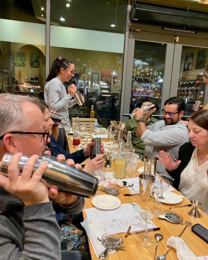 Adults gathered at a table for a cocktail class as a spring break bucket list idea when visiting Claremont.