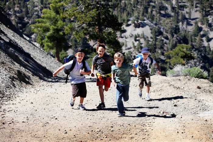 Four kids running on a trail near Claremont. It's a spring break bucket list idea next time visiting Claremont. 