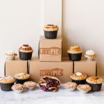 Boxes that say I Like Pie with mini pies on top and scattered about the table.
